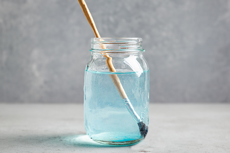 Picture of glass jar with brush being cleaned