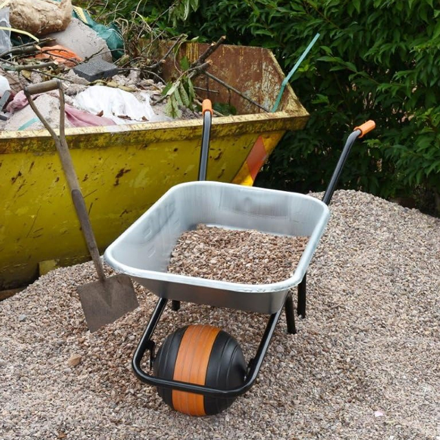 A picture of a wheelbarrow filled with gravel