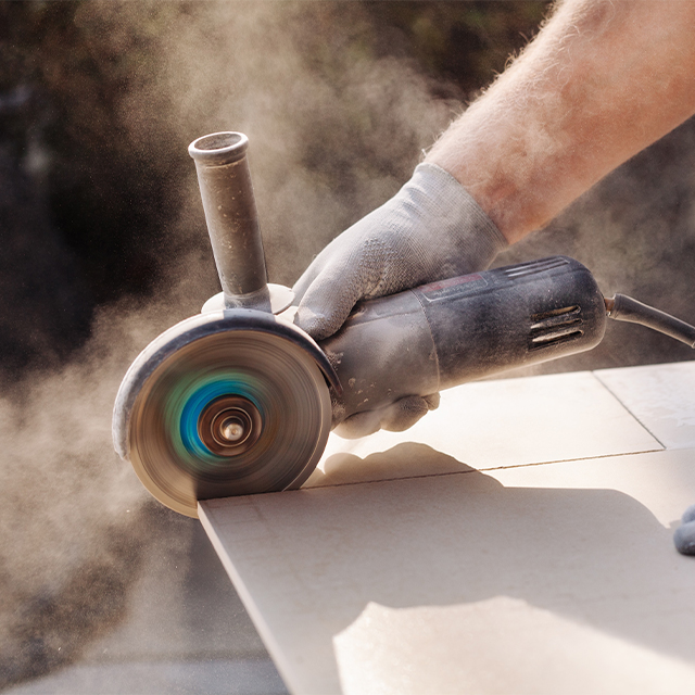 Picture of an angle grinder cutting a tile