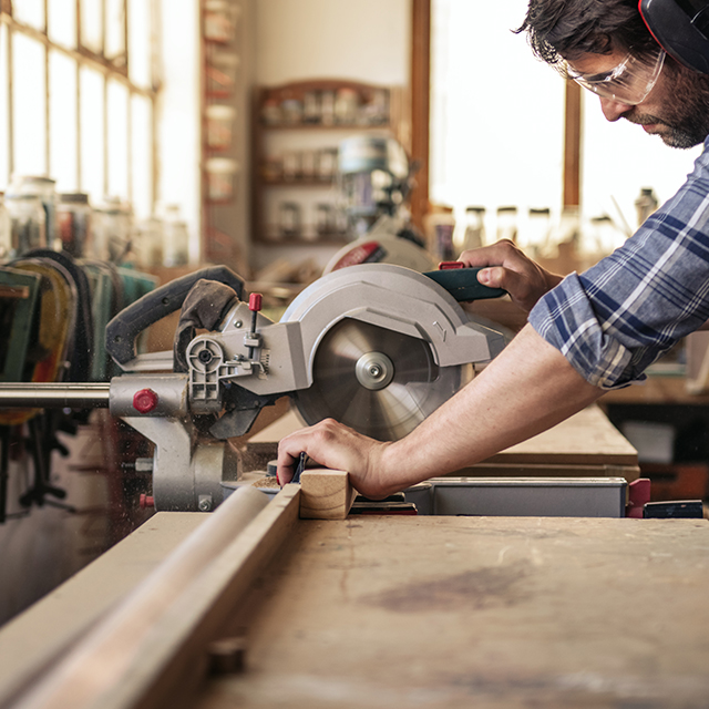 Picture of a man cutting with a mitre saw